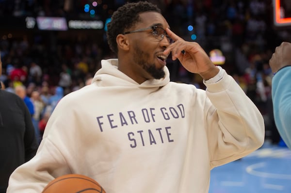 Cleveland Cavaliers' Donovan Mitchell smiles at the end of an NBA basketball game against the Charlotte Hornets in Cleveland, Sunday, Nov 17, 2024. (AP Photo/Phil Long)