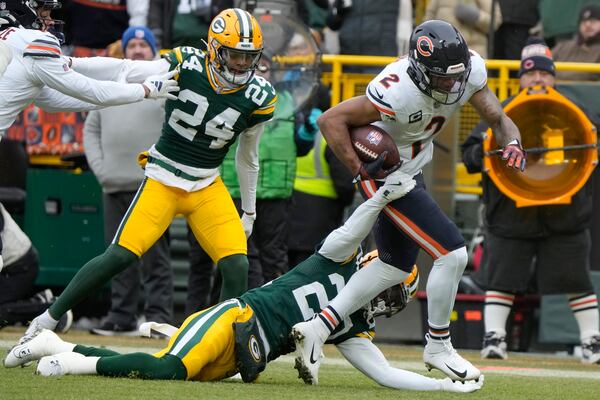 Chicago Bears wide receiver DJ Moore (2) runs against Green Bay Packers safety Javon Bullard, bottom, during the first half of an NFL football game, Sunday, Jan. 5, 2025, in Green Bay, Wis. (AP Photo/Morry Gash)