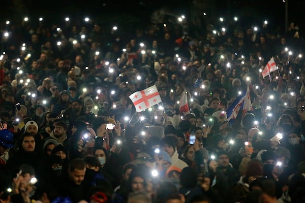 Demonstrators stand in front of police during a rally outside the parliament's building to protest the government's decision to suspend negotiations on joining the European Union for four years in Tbilisi, Georgia, on Saturday, Nov. 30, 2024. (AP Photo/Zurab Tsertsvadze)