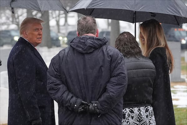 President-elect Donald Trump and Melina Trump talks with family members in Section 60 at Arlington National Cemetery, Sunday, Jan. 19, 2025, in Arlington, Va. (AP Photo/Evan Vucci)