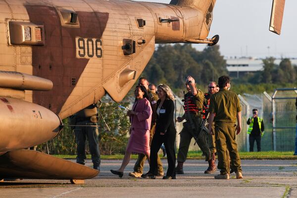 Thai ambassador to Israel Pannabha Chandraramya, left, arrives to an Israeli military helicopter carrying five Thai hostages released from Gaza after landing at Shamir Medical Center (Assaf Harofeh) in Be'er Ya'akov, Israel, Thursday, Jan. 30, 2025. (AP Photo/Maya Alleruzzo)