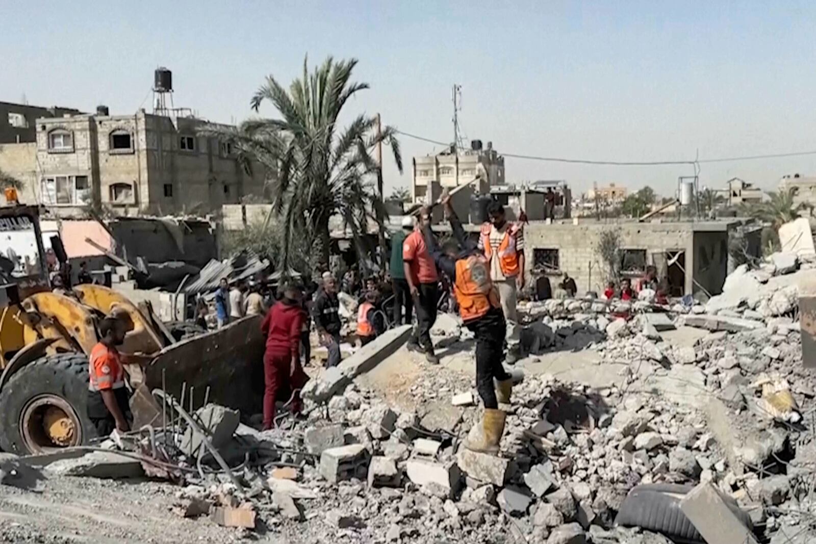 Palestinians check a building destroyed by Israeli airstrikes in the city of Khan Younis, southern Gaza Strip, Friday, Oct. 25, 2024. (AP Photo)