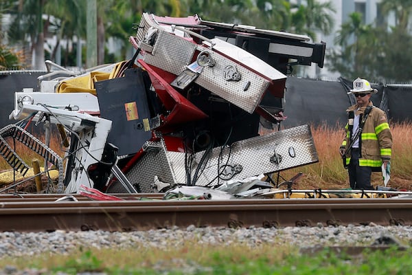 A fireman views damage after a Brightline train collided with a fire truck in downtown Delray Beach, Fla., Saturday, Dec. 28, 2024. (Mike Stocker/South Florida Sun-Sentinel via AP)