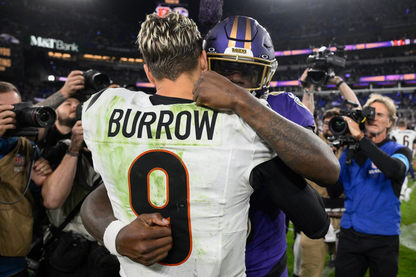 Cincinnati Bengals quarterback Joe Burrow (9) and Baltimore Ravens quarterback Lamar Jackson (8) embrace after an NFL football game, Thursday, Nov. 7, 2024, in Baltimore. The Ravens won 35-34. (AP Photo/Nick Wass)