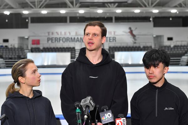 American figure skaters, from left, Alisa Efimova, Misha Mitrofanov, and Jimmy Ma, speak to members of the media at the The Skating Club of Boston, where several athletes, coaches and family associated with the club are believed to have perished in the collision of a passenger aircraft and military helicopter in Washington, Thursday, Jan. 30, 2025, in Norwood, Mass. (AP Photo/Steven Senne)