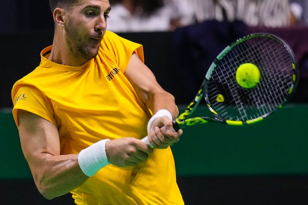 Australia's Thanasi Kokkinakis returns the ball against Italy's Matteo Berrettini during the Davis Cup semifinal at the Martin Carpena Sports Hall in Malaga, southern Spain, on Saturday, Nov. 23, 2024. (AP Photo/Manu Fernandez)