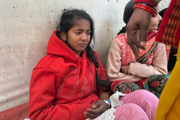 An injured girl reacts as she is being treated at a hospital after a stampede when Hindu devotees rushed to take a holy bath in the Sangam, the confluence of the Ganges, the Yamuna and the mythical Saraswati rivers, during the Maha Kumbh festival, in Prayagraj, India, Wednesday, Jan. 29, 2025. (AP Photo/Rajesh Kumar Singh)