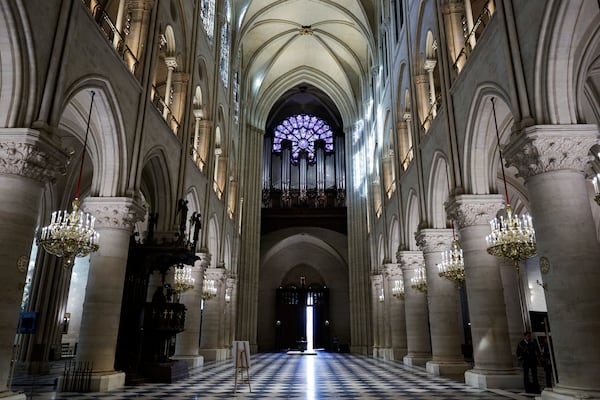 The nave, the western Rose window and the organ of Notre-Dame de Paris cathedral are seen while French President Emmanuel Macron visits the restored interiors of the monument, Friday Nov. 29, 2024, in Paris. (Stephane de Sakutin, Pool via AP)