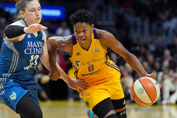 FILE - Los Angeles Sparks guard Alana Beard, right, drives past Minnesota Lynx guard Lindsay Whalen during the second half in Game 4 of the WNBA basketball finals, Sunday, Oct. 16, 2016, in Los Angeles. (AP Photo/Mark J. Terrill, File)