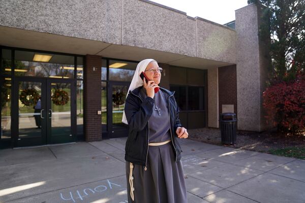 Sister Joan Paule Portenlanger of the Franciscan Sisters, T.O.R. of Penance of the Sorrowful Mother takes a phone call while working as campus ministry at Franciscan University, in Steubenville, Ohio, Thursday, Nov. 7, 2024. (AP Photo/Jessie Wardarski)