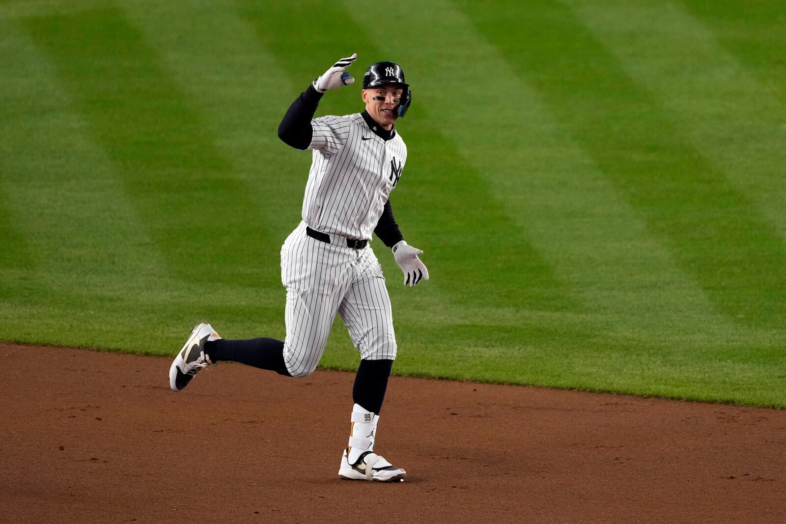 New York Yankees' Aaron Judge celebrates after hitting a two-run home run against the Cleveland Guardians during the seventh inning in Game 2 of the baseball AL Championship Series Tuesday, Oct. 15, 2024, in New York. (AP Photo/Seth Wenig)