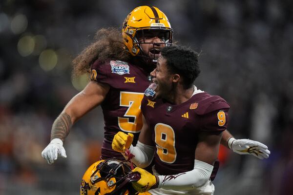 Arizona State linebacker Zyrus Fiaseu (30) and Montana Warren (9) celebrate a missed field goal by Texas during the second half in the quarterfinals of a College Football Playoff game, Wednesday, Jan. 1, 2025, in Atlanta. (AP Photo/Brynn Anderson)