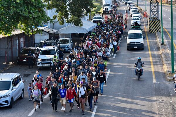 Migrants walk through Tapachula, Chiapas state, Mexico, Monday, Jan. 20, 2025, in an attempt to reach the U.S. border. (AP Photo/Edgar H. Clemente)