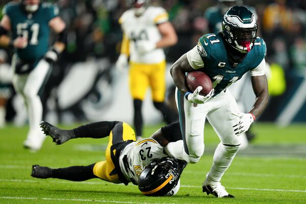 Philadelphia Eagles wide receiver A.J. Brown (11) is tackled by Pittsburgh Steelers safety Damontae Kazee (23) during the first half of an NFL football game Sunday, Dec. 15, 2024, in Philadelphia. (AP Photo/Derik Hamilton)