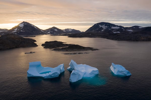 FILE - Large icebergs float away as the sun rises near Kulusuk, Greenland, on Aug. 16, 2019. (AP Photo/Felipe Dana, File)