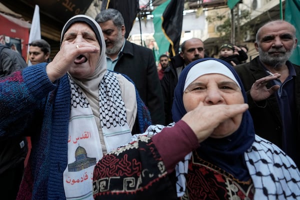 Palestinians let out a "zaghrouta" or joyous yell to celebrate a ceasefire agreement between Hamas and Israel at the Burj al-Barajneh Palestinian refugee camp, south of Beirut, Lebanon, Sunday, Jan. 19, 2025. (AP Photo/Hassan Ammar)