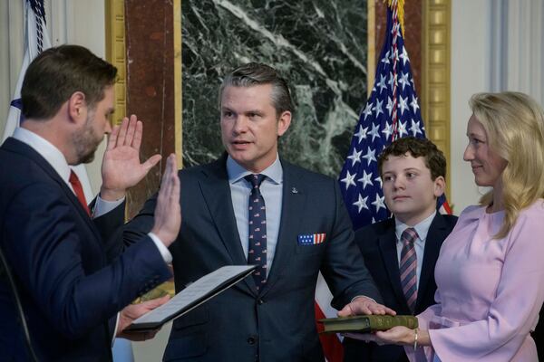 Vice President JD Vance, from left, swears in Pete Hegseth as Secretary of Defense as his wife Jennifer Rauchet, right, holds the Bible, as one of Hegseth's children watch in the Indian Treaty Room of the Eisenhower Executive Office Building on the White House campus in Washington, Saturday, Jan. 25, 2025. (AP Photo/Rod Lamkey, Jr.)