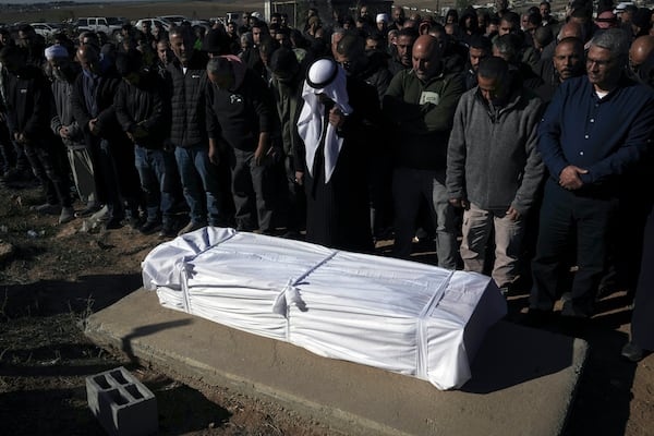 Members of the Bedouin community pray over the body of Yosef Al Zaydani, who was in Hamas captivity in the Gaza Strip, a day after the Israeli army said his body was recovered in an underground tunnel in southern Gaza, during his funeral in Rahat, southern Israel, Thursday, Jan. 9, 2025. (AP Photo/Mahmoud Illean)