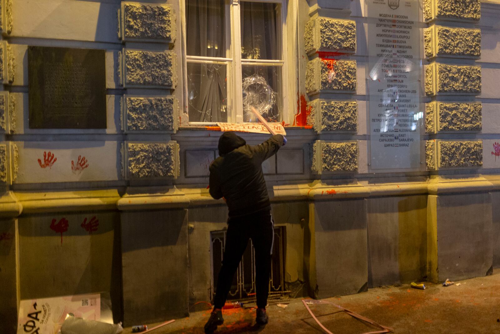 A protester crashes the window on the City Hall building during a protest in rage over last week's collapse of a concrete canopy at the railway station that killed 14 people in Novi Sad, Serbia, Tuesday, Nov. 5, 2024. (AP Photo/Marko Drobnjakovic)