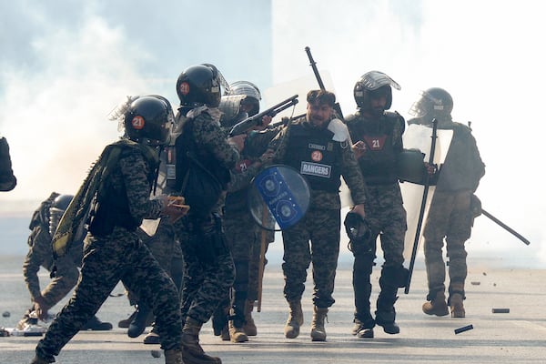 Paramilitary soldiers fire rubber bullets to disperse supporters of imprisoned former premier Imran Khan's Pakistan Tehreek-e-Insaf party, during clashes, in Islamabad, Pakistan, Tuesday, Nov. 26, 2024. (AP Photo/Irtisham Ahmed)