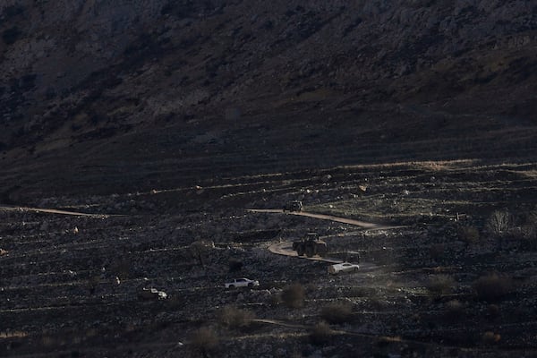 An Israeli bulldozer maneuvers on the buffer zone near the so-called Alpha Line that separates the Israeli-controlled Golan Heights from Syria, viewed from the town of Majdal Shams, Monday, Dec. 16, 2024. (AP Photo/Matias Delacroix)