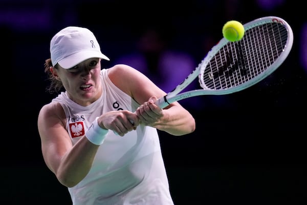 Poland's Iga Swiatek returns the ball to Spain's Paula Badosa during the Billie Jean King Cup Finals, at the Martin Carpena Sports Hall, in Malaga, southern Spain, on Friday, Nov. 15, 2024. (AP Photo/Manu Fernandez)