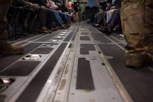 This photo provided by the U.S. Dept. of Defense, undocumented immigrants await takeoff in a A C-17 Globemaster III for a removal flight at the Tucson International Airport, Ariz., Jan. 23, 2024. (TSgt. Kimberly Nable/Dept. of Defense via AP)