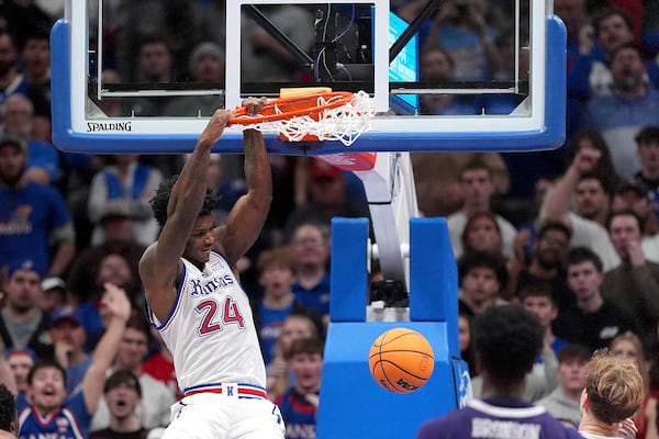 Kansas forward KJ Adams Jr. (24) dunks the ball during the second half of an NCAA college basketball game against Furman, Saturday, Nov. 30, 2024, in Lawrence, Kan. Kansas won 86-51. (AP Photo/Charlie Riedel)