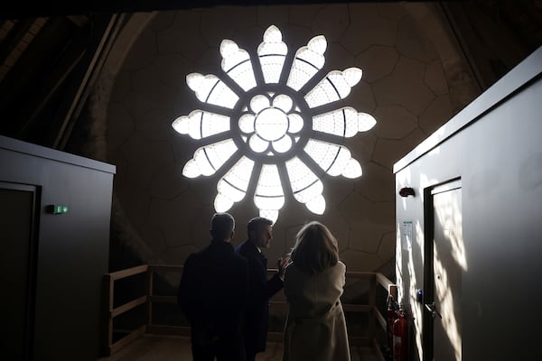 French President Emmanuel Macron, center, and his wife Brigitte Macron visit the restored interiors of the Notre-Dame de Paris cathedral, Friday, Nov.29, 2024 in Paris. (Christophe Petit Tesson, Pool via AP)