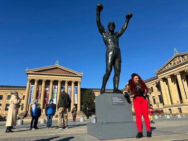 Visitors gather around the Rocky Statue and the “Rocky Steps” during RockyFest 2024 at the Philadelphia Museum of Art, Tuesday, Dec. 3, 2024, in Philadelphia. (AP Photo Tassanee Vejpongsa)