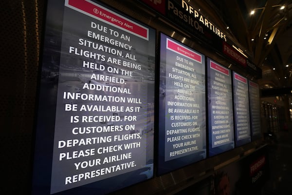 Information boards display information at Ronald Reagan Washington National Airport, Wednesday, Jan. 29, 2025, in Arlington, Va. (AP Photo/Julio Cortez)