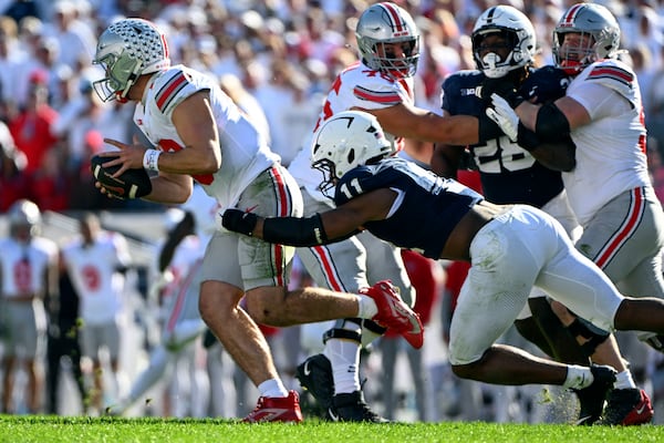 Penn State defensive end Abdul Carter (11) tackles Ohio State quarterback Will Howard (18) during the second half of an NCAA college football game against Ohio State, Saturday, Nov. 2, 2024, in State College, Pa. (AP Photo/Barry Reeger)