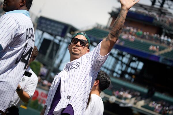 FILE - Retired Colorado Rockies outfielder Carlos Gonzalez waves to the crowd during a promotion to mark the team's 30th anniversary before the Rockies host the Oakland Athletics in a baseball game, July 30, 2023, in Denver. (AP Photo/David Zalubowski, file)