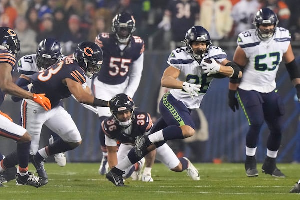 Seattle Seahawks running back Zach Charbonnet (26) runs with the ball against the Chicago Bears during the first half of an NFL football game, Thursday, Dec. 26, 2024, in Chicago. (AP Photo/Nam Y. Huh)