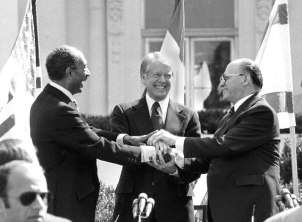 FILE - Egyptian President Anwar Sadat, left, U.S. President Jimmy Carter, center, and Israeli Prime Minister Menachem Begin clasp hands at the White House in Washington after signing the peace treaty between Egypt and Israel, March 26, 1979. Sadat and Begin were awarded the Nobel Peace Prize in 1978. Carter received the Nobel Peace Prize himself in 2002 "for his decades of untiring effort to find peaceful solutions to international conflicts." (AP Photo/Bob Daugherty, File)