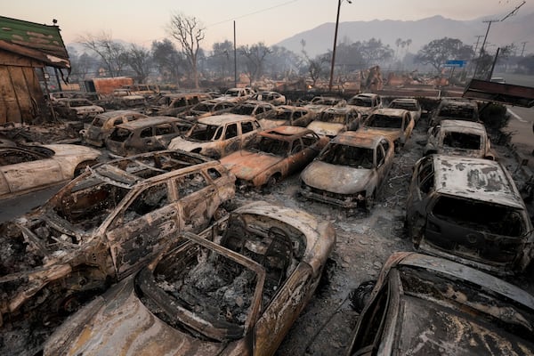 Cars are left charred inside a dealership in the aftermath of the Eaton Fire Friday, Jan. 10, 2025 in Altadena, Calif. (AP Photo/Jae C. Hong)