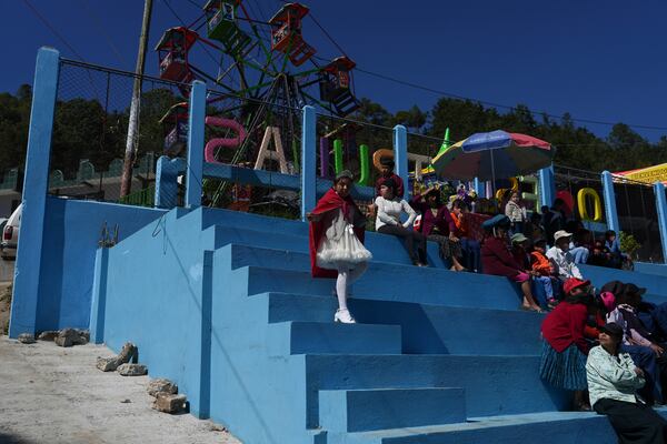 People watch the performance of The Dance of the Conquest of Guatemala, depicting Spain's 1524 invasion of the K'iche' kingdom in Tejutla, in Guatemala's San Marcos department, on the feast day of the Black Christ of Esquipulas, Wednesday, Jan. 15, 2025. (AP Photo/Moises Castillo)