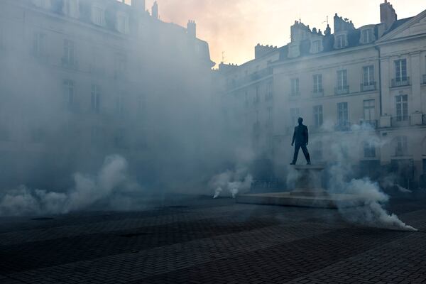 Demonstrators set off smoke flares as they react to projected results after the second round of the legislative elections, Sunday, July 7, 2024 in Nantes, western France. Polls have closed in France, and polling projections say a coalition on the left that came together unexpectedly has won the most parliamentary seats in the pivotal runoff elections after a high turnout among voters. (AP Photo/Jeremias Gonzalez)