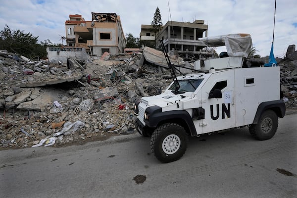 A South Korean U.N peacekeeper armoured vehicle drives by destroyed buildings in Chehabiyeh village, southern Lebanon, Thursday, Nov. 28, 2024 following a ceasefire between Israel and Hezbollah that went into effect on Wednesday. (AP Photo/Hussein Malla)