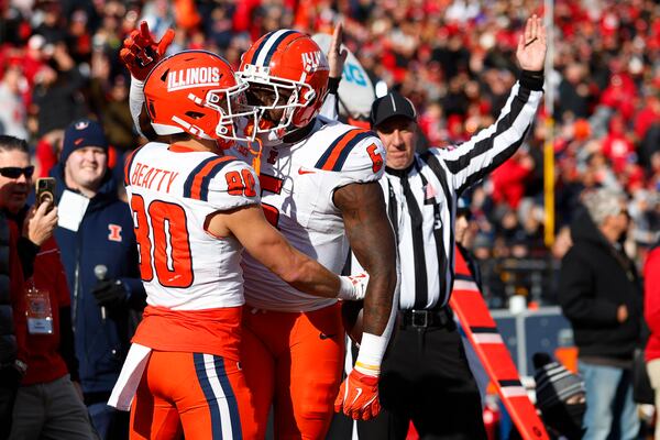 Illinois wide receiver Hank Beatty (80) is congratulated by running back Josh McCray (6) after making a touchdown catch against Rutgers during the first half of an NCAA college football game, Saturday, Nov. 23, 2024, in Piscataway, N.J. (AP Photo/Rich Schultz)