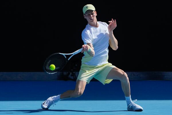 Jannik Sinner of Italy plays a forehand return to Nicolas Jarry of Chile during their first round match at the Australian Open tennis championship in Melbourne, Australia, Monday, Jan. 13, 2025. (AP Photo/Asanka Brendon Ratnayake)