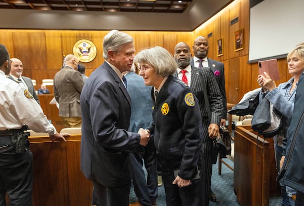 New Orleans Police Superintendent Anne Kirkpatrick, center, shakes hands with Rafael Goyeneche, left, president of the Metropolitan Crime Commission, on her way out of Federal Court, Tuesday, Jan. 14, 2025, in New Orleans, after a judge ruled the New Orleans Police Department can begin the process of ending longstanding federal oversight. (Chris Granger/The Times-Picayune/The New Orleans Advocate via AP)