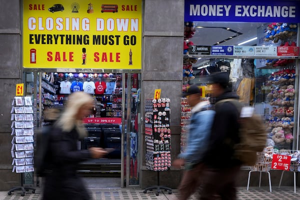 Pedestrians pass a closing down sign on a souvenir shop in Oxford Street in London, Friday, Nov. 15, 2024. (AP Photo/Kirsty Wigglesworth)