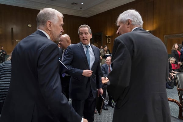 FILE - Michael Barr, Vice Chairman For Supervision of the Board of Governors of the Federal Reserve System, center, stands along with Sen. Thom Tillis, R-N.C., left, and Federal Deposit Insurance Corporation (FDIC) Chairman Martin Gruenberg as a Senate Banking, Housing and Urban Affairs hearing concludes on Capitol Hill, in Washington, March 28, 2023. (AP Photo/Manuel Balce Ceneta, File)