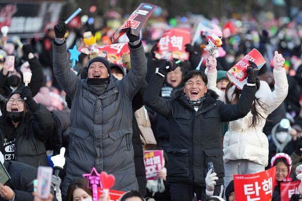 FILE - Participants celebrate after hearing the news that South Korea's parliament voted to impeach President Yoon Suk Yeol outside the National Assembly in Seoul, South Korea, Saturday, Dec. 14, 2024. (AP Photo/Lee Jin-man, File)