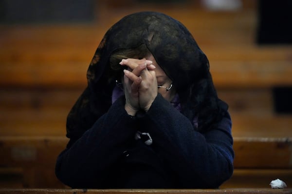 A Syrian Christian woman prays, as she attends the first Sunday Mass since Syrian President Bashar Assad's ouster, at Mariamiya Orthodox Church in old Damascus, Syria, Sunday, Dec. 15, 2024. (AP Photo/Hussein Malla)