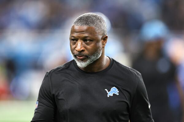 Detroit Lions defensive coordinator Aaron Glenn watches during warmups before an NFL football divisional playoff game against the Washington Commanders, Saturday, Jan. 18, 2025, in Detroit. (AP Photo/Mike Mulholland)