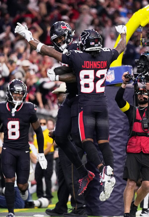 Houston Texans wide receiver Nico Collins, rear, celebrates with Diontae Johnson (82) after scoring a touchdown against the Los Angeles Chargers during the first half of an NFL wild-card playoff football game Saturday, Jan. 11, 2025, in Houston. (AP Photo/Eric Christian Smith)