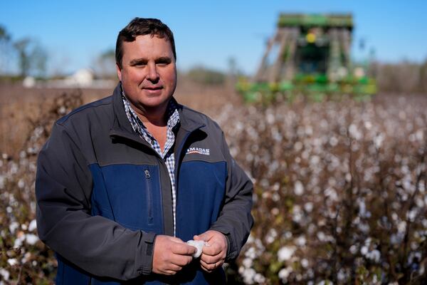 Farmer Chris Hopkins stands in one of his cotton fields before being harvested, Friday, Dec. 6, 2024, near Lyons, Ga. (AP Photo/Mike Stewart)