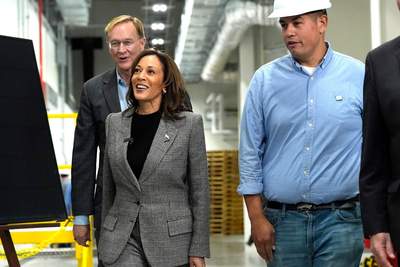 Democratic presidential nominee Vice President Kamala Harris, from second right, tours the Hemlock Semiconductor Next-Generation Finishing facility as Corning Chairman and CEO Wendell Weeks looks on, in Hemlock, Mich., Monday, Oct. 28, 2024. (AP Photo/Jacquelyn Martin)